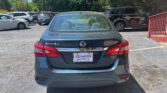 Rear view of a dark gray Nissan Sentra SV parked in a lot; dealer plate reads Atlanta Autostar/Atlanta Autostar frame is visible.