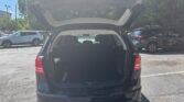 Black SUV with large open tailgate revealing the trunk, parked in a sunny lot.