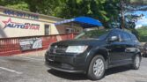 Black SUV parked in front of Atlanta Auto Star dealership with a blue awning and the store sign visible