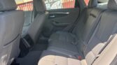 Spacious rear passenger area of a sedan with gray fabric seats, three headrests, and door panels.