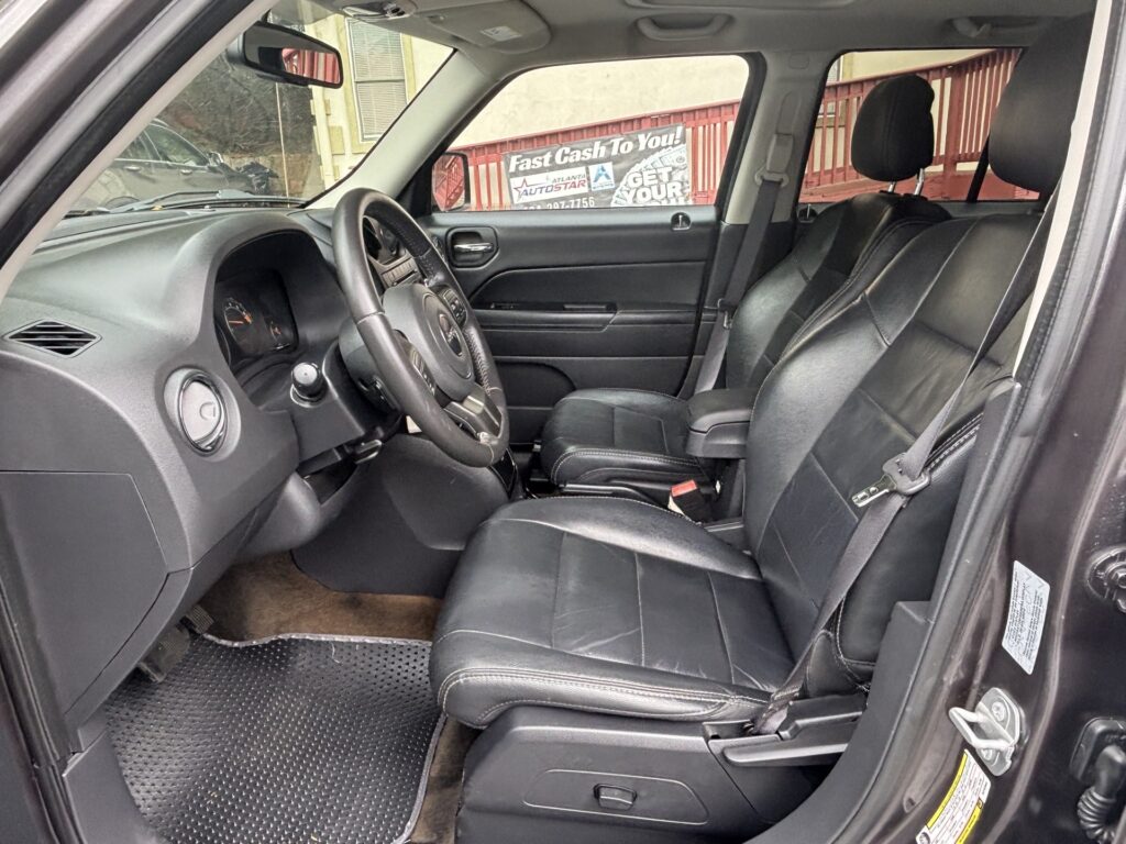 Dark leather SUV interior with steering wheel and front seats; banner reading 'Fast Cash To You' visible through the driver window.