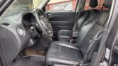 Dark leather SUV interior with steering wheel and front seats; banner reading 'Fast Cash To You' visible through the driver window.