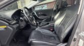 Black leather front seats and dashboard of a Hyundai Azera, viewed from the driver's door open.
