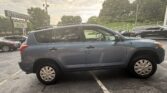 Blue SUV parked in a used-car lot with other vehicles and a sign in the background reading Auto Star Atlanta.