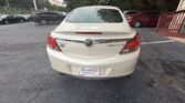Rear of a white Buick Regal LT in a car dealership lot, with Atlanta Autostar plate.