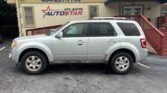 Silver SUV parked in front of a yellow Atlanta Auto Star dealership building with a blue awning; the sign reads 'Atlanta Auto Star' and the phone number 404-297-7756.