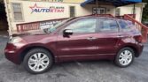 Maroon crossover SUV parked in front of the Atlanta AutoStar dealership, with the phone number 404-297-7756 visible on the building sign.