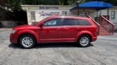 Red SUV parked in front of a building with 'Atlanta AutoStar' sign and a blue awning overhead